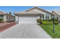 Charming single-story home with a well-manicured lawn and a two-car garage at 4924 Cedar Lawn Way, Las Vegas, NV 89130