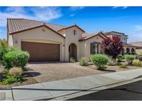 Charming home featuring a tile roof, desert landscaping, and brick driveway at 5713 Silver Cascade Ave, Las Vegas, NV 89131