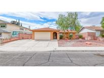 Single-story home with attached garage, mature trees, and low-maintenance rock landscaping at 632 Arrayo Way, Boulder City, NV 89005
