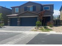 Charming two-story home with a two-car garage and a beautifully landscaped front yard at 7527 Ardenno St, North Las Vegas, NV 89084