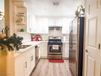 Bright kitchen featuring stainless steel appliances, white cabinets, and modern countertops at 8324 W Charleston Blvd # 1036, Las Vegas, NV 89117