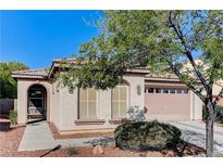 Charming single-story home featuring a desert landscape and a two-car garage at 10410 Nostalgia Cir, Las Vegas, NV 89135
