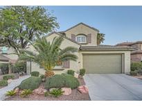 Charming two-story home with landscaped yard, desert landscaping, and attached two car garage at 11345 Espadrille Ct, Las Vegas, NV 89138