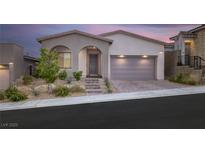 Charming single-story home featuring desert landscaping, an arched entryway, and a spacious two-car garage at 11617 Peregrine Point Ct, Las Vegas, NV 89138