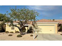 Inviting single-story home featuring a well-maintained yard and mature landscaping at 2056 Oliver Springs St, Henderson, NV 89052