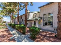 Charming townhomes feature well-maintained landscaping, mature trees, and inviting curb appeal at 2451 Old Forge Ln # 105, Las Vegas, NV 89121