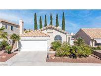 Charming single-story home featuring a tiled roof, arched window, and lush landscaping at 2708 Norbeck St, Las Vegas, NV 89117
