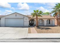 Charming single-story home featuring a two-car garage and well-maintained front yard with mature trees at 3661 Margarita Way, Las Vegas, NV 89103