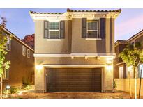 Charming two-story home featuring a two-car garage and a brick paved driveway providing excellent curb appeal at 39 Castleton Tower Ct, Henderson, NV 89011