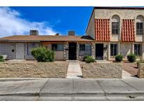 Charming townhome featuring unique stonework, a red tile roof, and well-maintained landscaping at 3912 Palos Verdes St, Las Vegas, NV 89119