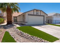 Charming single-story home with a two-car garage and landscaped front yard featuring a decorative rock stream at 4481 Faberge Ave, Las Vegas, NV 89115