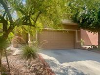 Traditional two-car garage with desert landscaping and a concrete driveway offering ample parking space at 4951 Ivylyn Ct, Las Vegas, NV 89122