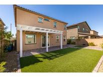 An outdoor living space featuring a pergola, paver patio, and artificial grass for low-maintenance enjoyment at 528 Sunny Pointe St, Henderson, NV 89011
