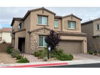 Inviting two-story home with stone accents, a two-car garage, and a well-maintained front yard at 528 Sunny Pointe St, Henderson, NV 89011