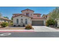 Inviting two-story home features a neutral color palette, red tile roof, and manicured landscaping at 6424 Grayback Dr, North Las Vegas, NV 89084