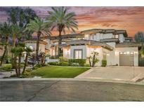 Stunning multi-story home with lush landscaping, palm trees, and a long driveway at 764 Ricota Ct, Henderson, NV 89012