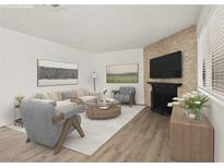 Bright living room with a decorative fireplace, modern furniture, and plenty of natural light from the large window at 829 Rock Springs Dr # 201, Las Vegas, NV 89128
