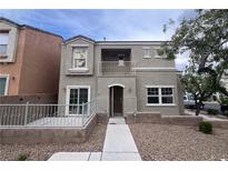 Two-story home with a front patio, balcony, and xeriscaped yard offers stylish curb appeal at 9148 Alluring Ave, Las Vegas, NV 89149