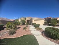 Inviting single-story home with desert landscaping, walkway, and attached two car garage at , Henderson, NV 89044