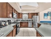 Well-lit kitchen features stainless steel appliances and updated countertops at 10113 Walhalla Plateau Ct, Las Vegas, NV 89148