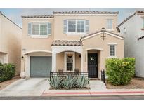 Charming two-story home with desert landscaping, covered entry and front porch, and an attached garage at 10400 Beautiful Fruit St, Las Vegas, NV 89183