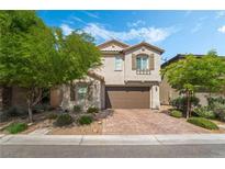 Charming two-story home with a well-manicured front yard and brick driveway at 10565 Olinda St, Las Vegas, NV 89179