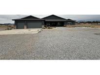 Charming single-story home with gravel front yard and attached two-car garage at 1830 Justine Ct, Pahrump, NV 89048