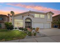 Charming two-story home showcasing beautiful landscaping, green grass, and a desert-style front yard at 222 Hollyfern St, Henderson, NV 89074