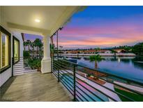 Inviting balcony overlooking the tranquil lake, palm trees and picturesque sunset views at 2589 Sun Reef Rd, Las Vegas, NV 89128