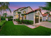 Charming two-story home with a red tile roof, an attached two-car garage, and an artificial lawn at 2589 Sun Reef Rd, Las Vegas, NV 89128