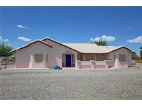 Charming single-story home with desert landscaping, light stucco, and a blue door at 2650 Sagebrush Ave, Pahrump, NV 89048