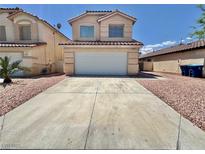 Tan two-story home showcasing a two-car garage and low-maintenance rock landscaping at 3919 Lilac Haze St, Las Vegas, NV 89147