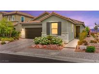 Charming single-story home with a well-manicured front yard and a two-car garage on a brick driveway at 5530 Hill Spire St, Las Vegas, NV 89166