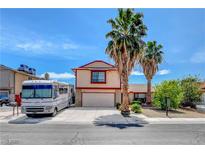 Two-story home with red trim, palm trees, RV parked in front of the attached garage at 5731 Fonchester Ct, Las Vegas, NV 89110