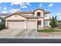 Charming two-story home boasts a three-car garage, manicured lawn, and inviting curb appeal at 5769 Larkdale St, Las Vegas, NV 89120