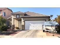 Charming single-story home with a two-car garage and well-maintained landscaping in a residential neighborhood at 6030 Halehaven Dr, Las Vegas, NV 89110