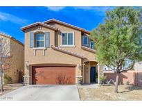 Charming two-story home featuring a brown garage door, desert landscaping, and blue shutters at 6276 Point Isabel Way, Las Vegas, NV 89122