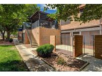 Inviting two-story home with a balcony, private entrance, and fenced front yard with desert landscaping at 6641 Silverstream Ave # C, Las Vegas, NV 89107