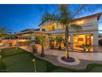 Stunning backyard with putting green, bar, and lush landscaping perfect for outdoor entertaining at 724 Step Beach St, Las Vegas, NV 89138