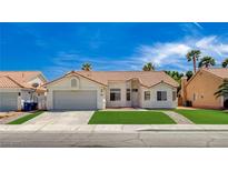 Charming single-story home with a well-maintained front lawn, desert landscaping, and a two-car garage at 7927 W Oquendo Rd, Las Vegas, NV 89113