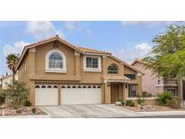 Charming two-story home featuring a tile roof, stucco exterior, and well-maintained landscaping at 8216 Brittany Harbor Dr, Las Vegas, NV 89128