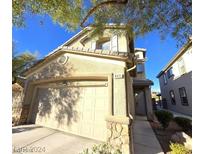 Charming two-story home featuring an attached two-car garage with stone accents, and well-maintained landscaping at 849 Purdy Lodge St, Las Vegas, NV 89138