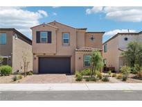 Charming two-story home with desert landscaping, a brick driveway, and attached two-car garage at 8724 Scalpay St, Las Vegas, NV 89166