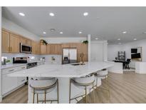 Bright kitchen featuring an oversized island with white marble countertop and stainless steel appliances at 10389 Felice Ave, Las Vegas, NV 89135
