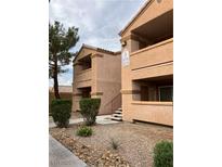 Multi-story condo building with private balconies and manicured landscaping at 1150 N Buffalo Dr # 2093, Las Vegas, NV 89128