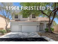 Charming two-story home with a tile roof, three-car garage, and mature landscaping in a well maintained yard at 11698 Firesteed Pl, Las Vegas, NV 89141