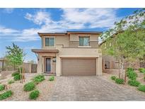 Two-story home showcasing a welcoming facade, complemented by a brick driveway and tidy landscaping at 12341 Ferry Glide Ave, Las Vegas, NV 89138