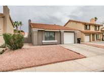 Charming single-story home with a red tile roof and low-maintenance landscaping at 1744 La Cruz Dr, Henderson, NV 89014