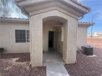 Inviting front entrance with covered porch and desert landscaping featuring low-maintenance rock at 1881 W Alexander Rd # 1035, North Las Vegas, NV 89032