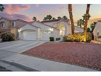 Charming home featuring a three-car garage, mature trees, landscape beds and a terra cotta roof at 2024 Spruce Brook Dr, Henderson, NV 89074